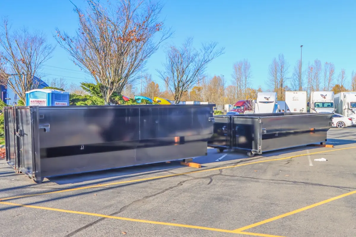 Professional dumpster rental service with roll-off container on residential driveway in Duvall